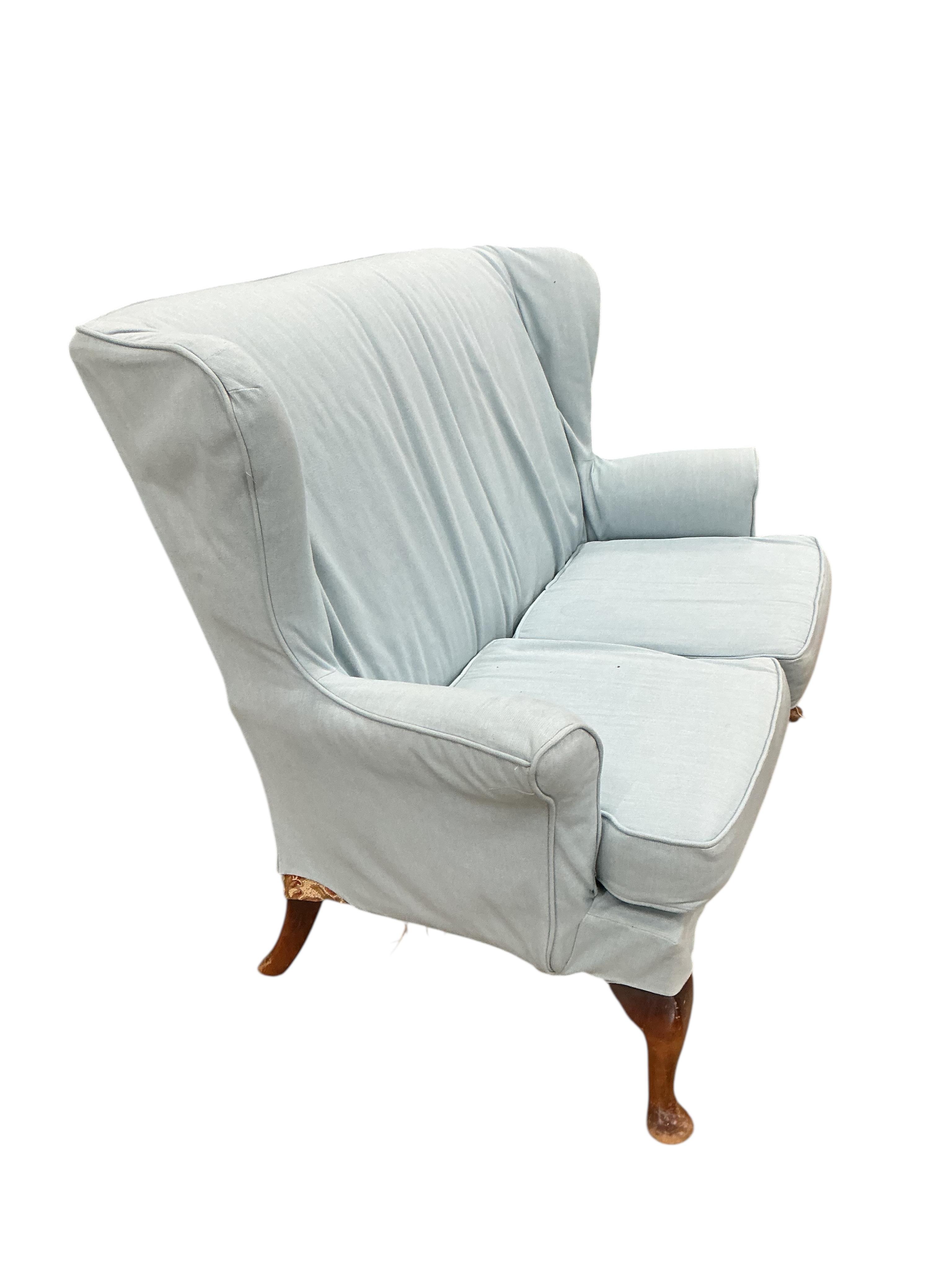 A Parker Knoll wing back upholstered two seater settee, width 136cm, depth 70cm, height 96cm